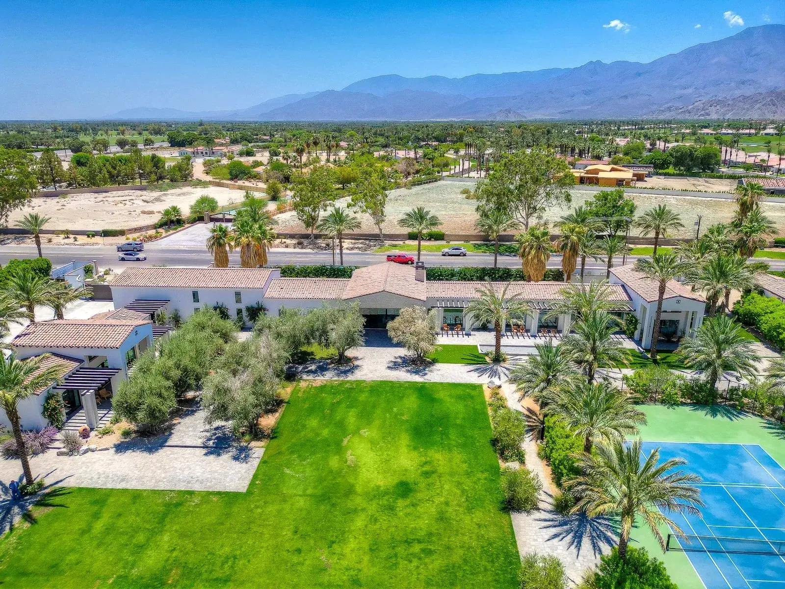 Wide aerial view of Cache Estate against the desert mountains