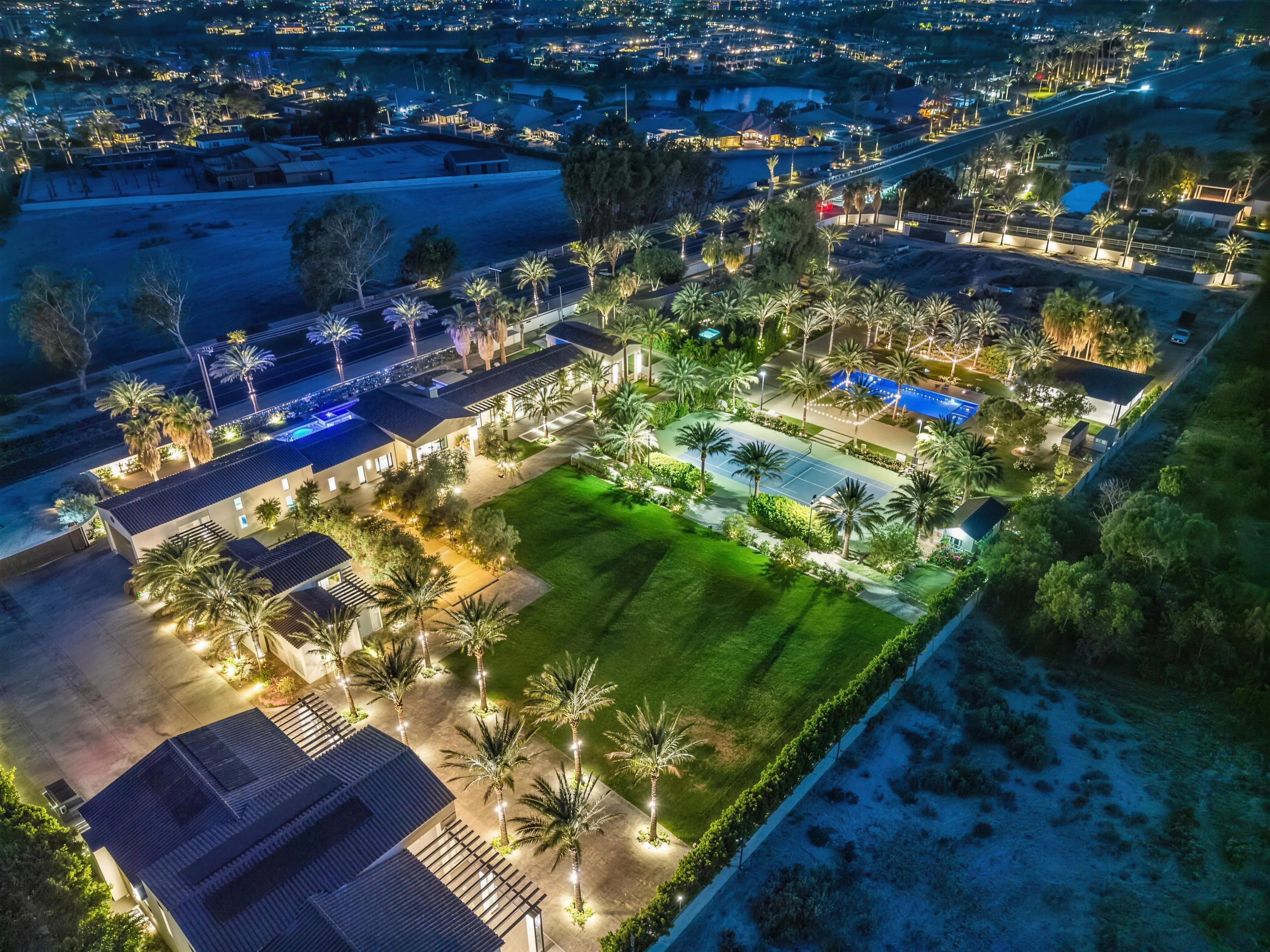 Cache Estate illuminated at night against the Coachella Valley