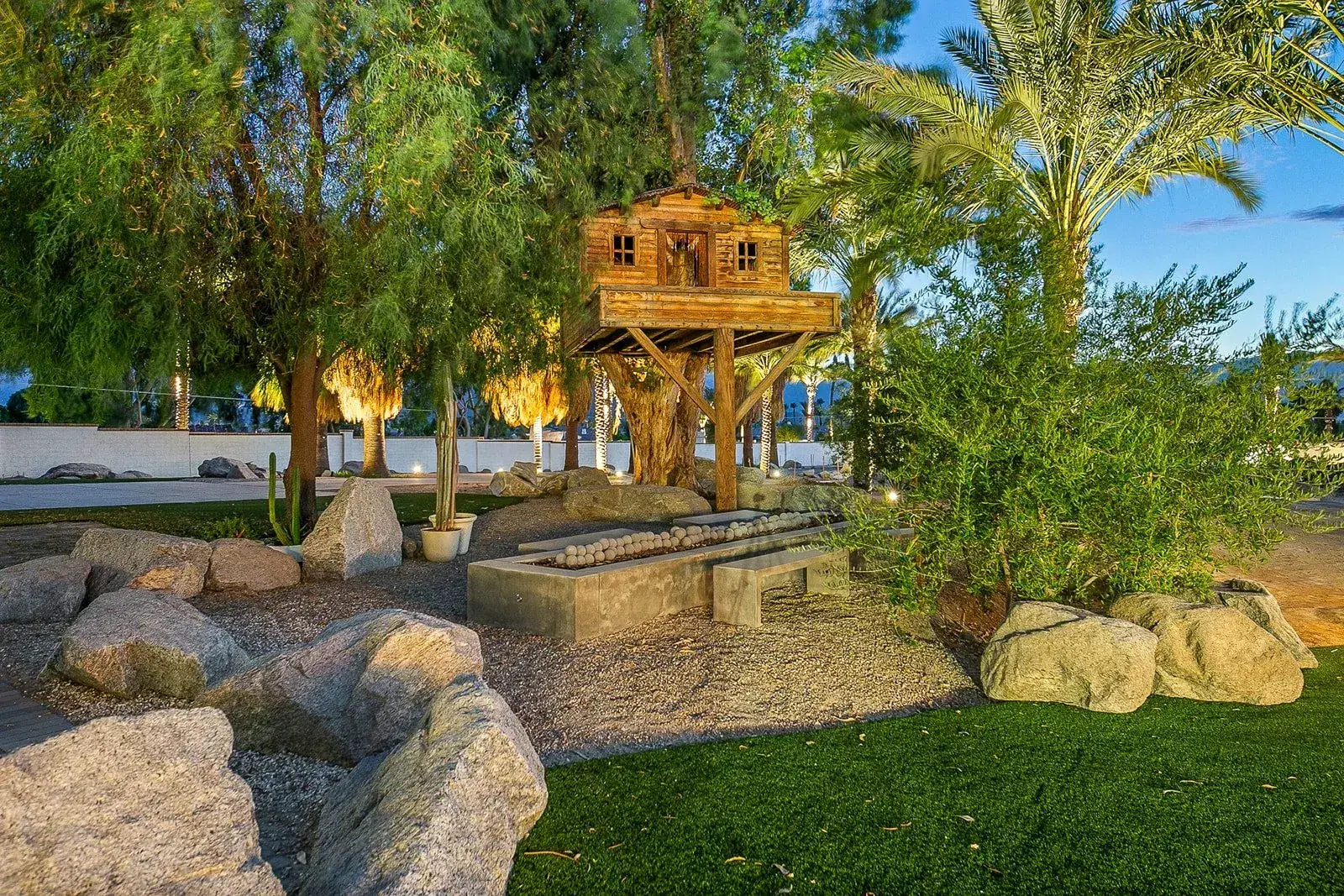 A raised timber treehouse on the grounds