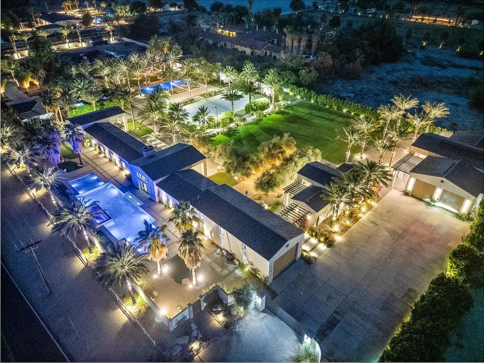 Cache Estate lit at night against the dark valley